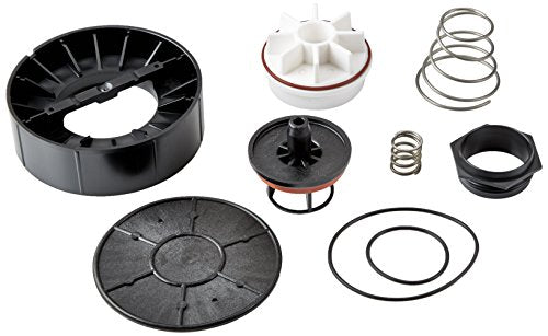 Pressure vacuum breaker repair kit components including black plastic housing parts, white diaphragm discs, metal springs, an