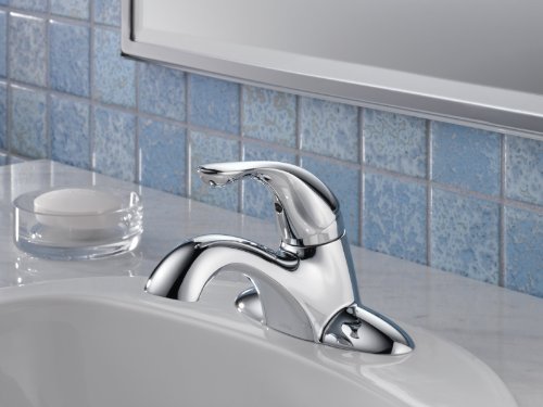Chrome single-handle bathroom faucet with curved lever and arched spout mounted on sink.