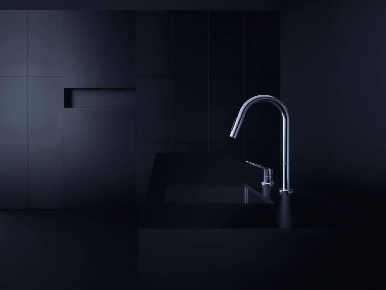 Steel Optic pull-down kitchen faucet with curved spout and single lever handle mounted on black sink.