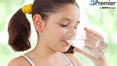 Child drinking filtered water from clear glass.