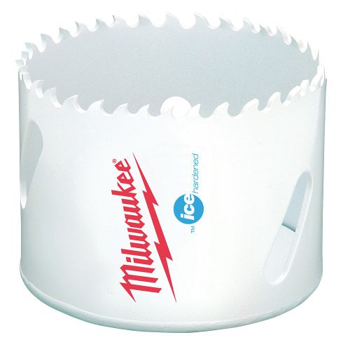 White bi-metal hole saw with jagged cutting edge, Milwaukee branding, and size markings on cylindrical body.