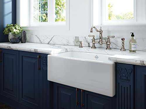 English bronze soap dispenser with decorative pump mechanism positioned on marble countertop next to farmhouse sink.