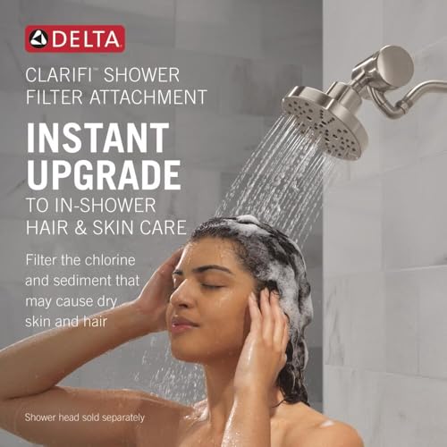 Matte black Delta Clarifi shower filter attachment with chrome arm and round shower head, water streaming down.