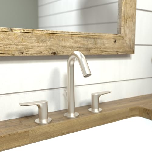 Brushed nickel three-piece widespread bathroom faucet with curved spout and lever handles on wooden vanity.