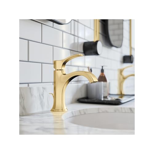 Brushed gold single-hole bathroom faucet with curved spout and pop-up drain on marble sink.