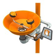 Orange plastic eyewash station with dual eye wash bowl, foot pedal activation, and wall-mount pole bracket.
