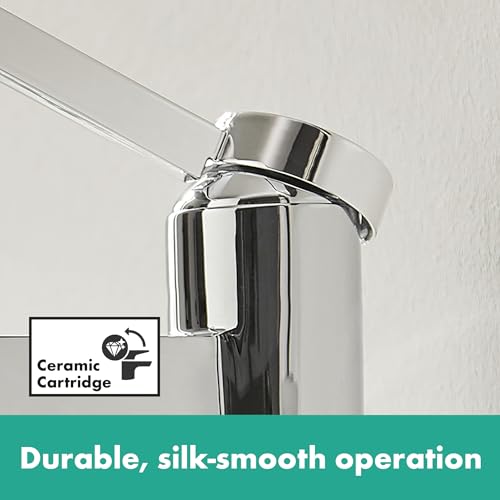 Brushed nickel single-hole bathroom faucet with cylindrical body and curved handle against white wall.