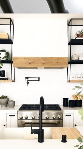 Matte black single-handle pulldown kitchen faucet with spray head mounted above stainless steel cooktop.