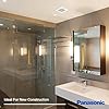 Bathroom with glass-enclosed shower, white vanity, and ceiling-mounted ventilation fan.