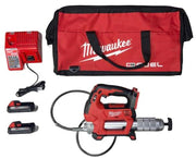 Milwaukee M18 grease gun kit with charger, two batteries, carrying bag, and hoses.