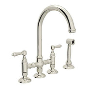 Polished nickel bridge kitchen faucet with high arched spout, dual lever handles, and separate side spray.