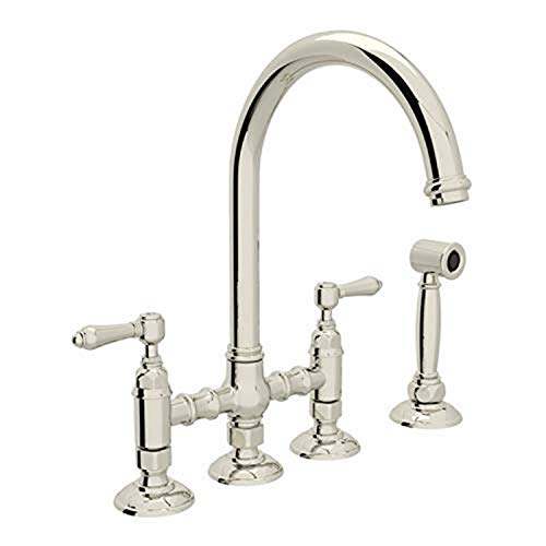 Polished nickel bridge kitchen faucet with high arched spout, dual lever handles, and separate side spray.