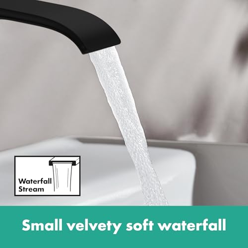 Matte black single-hole bathroom faucet with curved spout dispensing water in a waterfall stream pattern.
