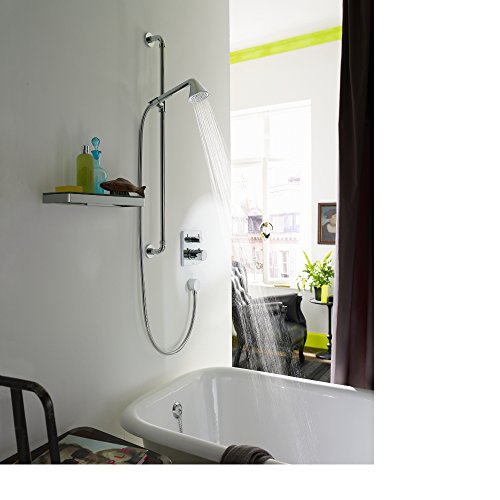 Brushed nickel wall-mounted shower system with overhead rainfall head, hand spray, and control outlets installed above bathtu