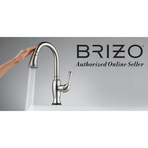 Brushed nickel pull-down kitchen faucet with curved spout and hand shower spraying water.