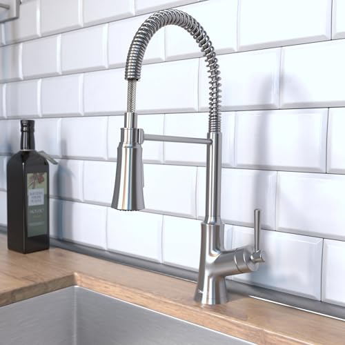 Stainless steel semi-pro kitchen faucet with flexible coiled spray hose mounted on countertop with white subway tile backspla