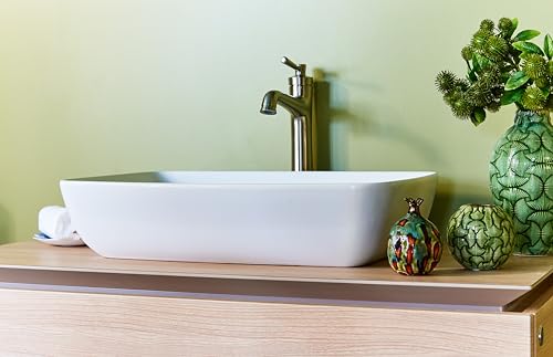 Brushed nickel single-hole faucet with tall spout mounted on white rectangular vessel sink.