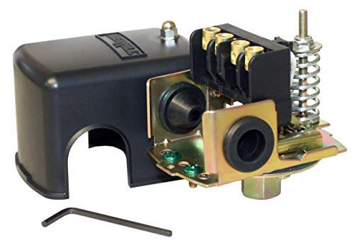 Heavy-duty pressure switch with dark blue housing, brass components, spring mechanism, and adjustment wrench.
