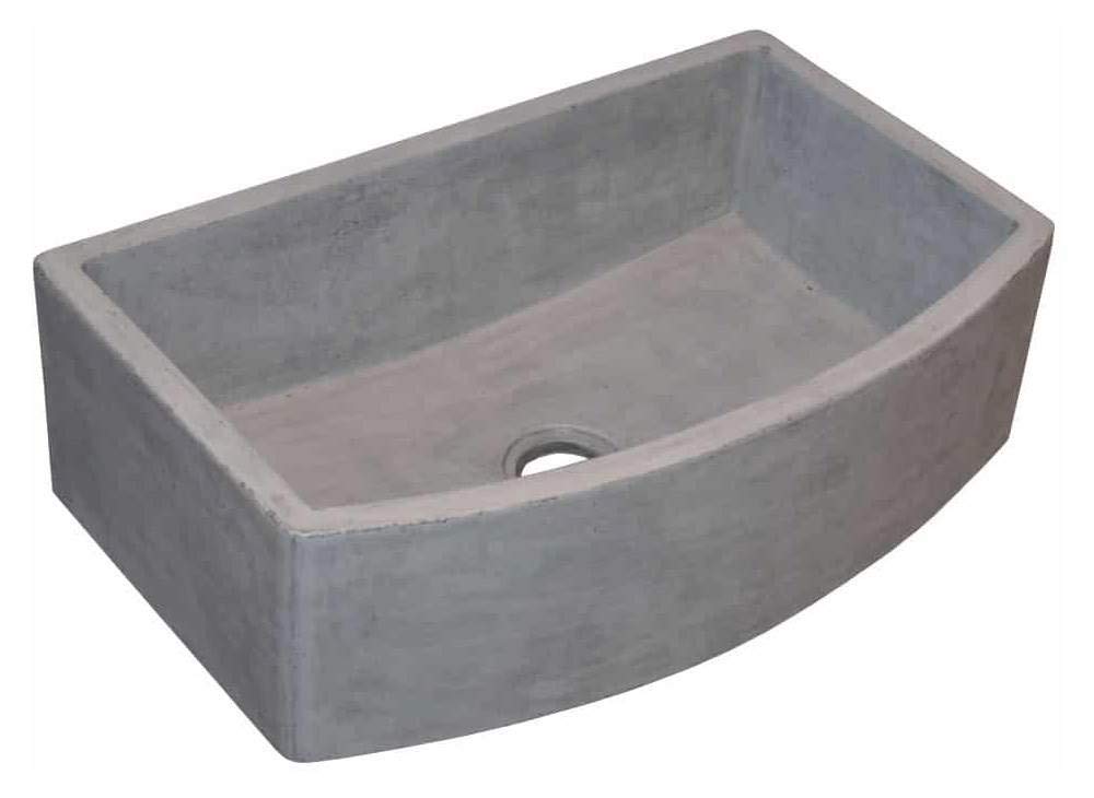 Gray concrete farmhouse sink with curved apron front and single drain hole.