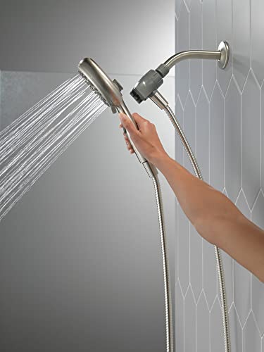 Hand held shower head in satin nickel with water streams, mounted on wall with flexible hose and arm bracket.