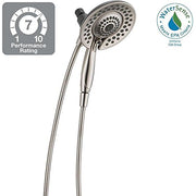 Dual brushed nickel showerheads with flexible hoses and performance rating badge.