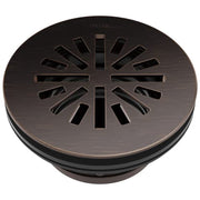Round shower drain in Venetian bronze with radial slot pattern and Delta branding on cover.