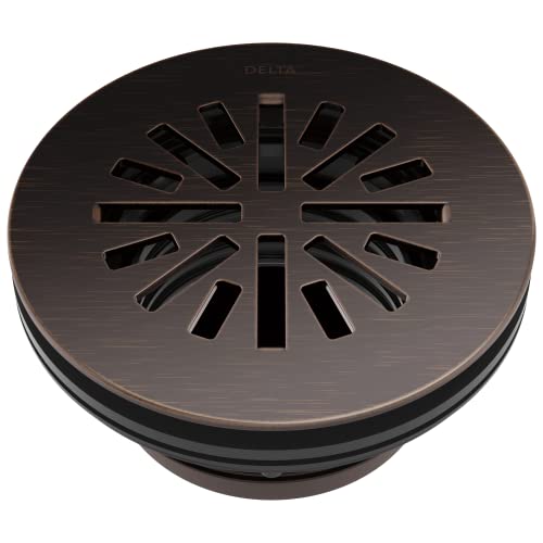 Round shower drain in Venetian bronze with radial slot pattern and Delta branding on cover.