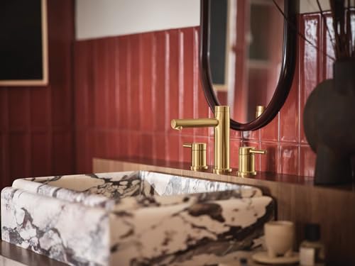 Brushed gold two-handle widespread bathroom faucet trim kit with modern styling installed above marble sink.