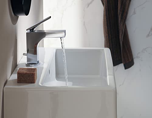 Chrome single-hole bathroom faucet with angular spout and lever handle over white ceramic sink.