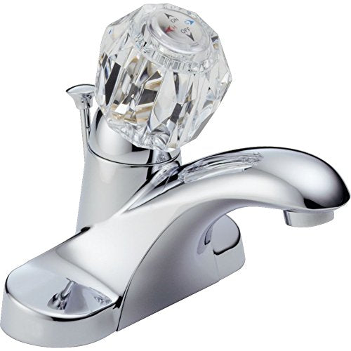 Chrome bathroom faucet with curved spout and clear faceted crystal handle.