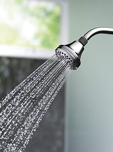 Chrome shower head with five spray massage settings dispersing water downward from curved arm.