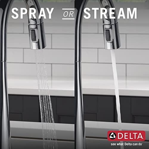 Chrome pull-down kitchen faucet with dual spray and stream modes over kitchen sink.