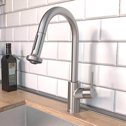 Steel Optic pull-down kitchen faucet with curved spout and single lever control mounted on white subway tile backsplash.