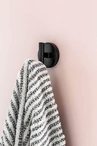 Polished nickel robe hook mounted on wall with striped towel hanging from hook.