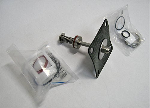 Watts RPZ 909 repair kit containing metal spring assembly, black plastic valve body, threaded bolt, and small packaged rubber
