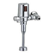 Chrome commercial battery flush valve with sensor box and side control lever mounted on vertical pipe.