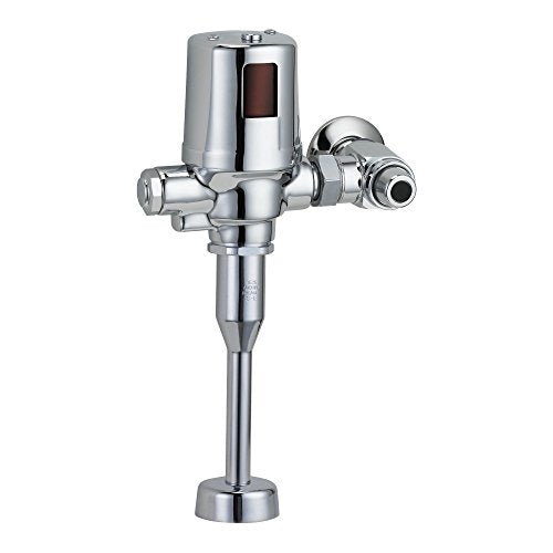 Chrome commercial battery flush valve with sensor box and side control lever mounted on vertical pipe.