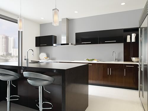 Chrome single-handle kitchen faucet with pull-down spray head installed over black island countertop in modern kitchen.