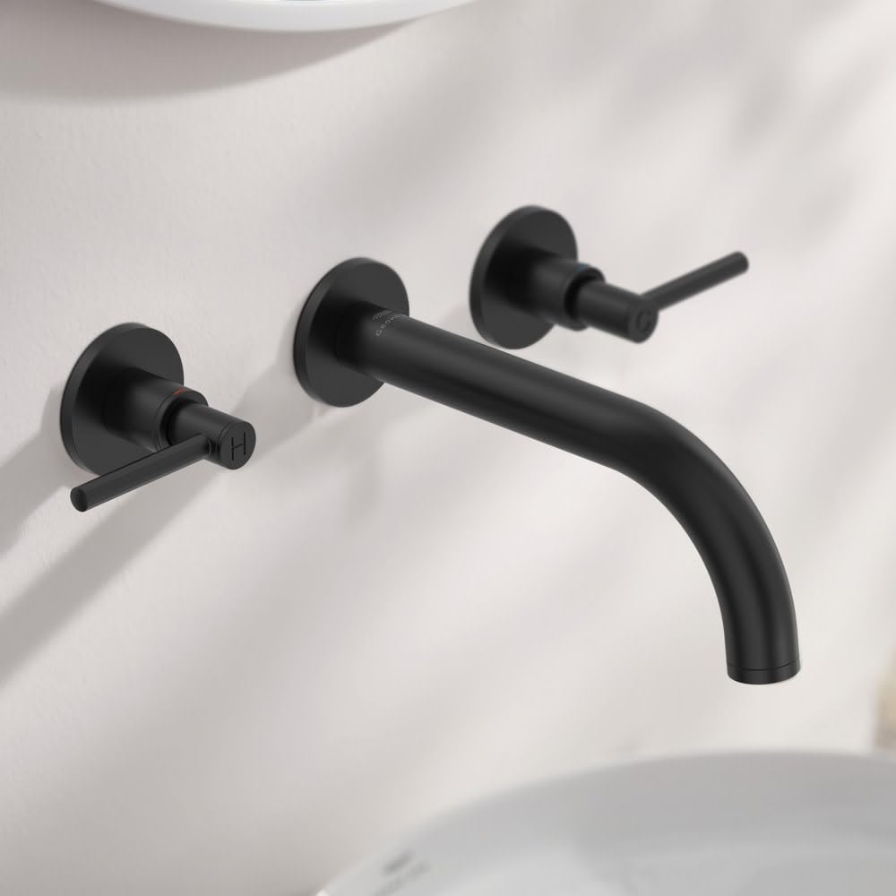 Pair of black matte lever handles with circular wall plates mounted on white sink basin.