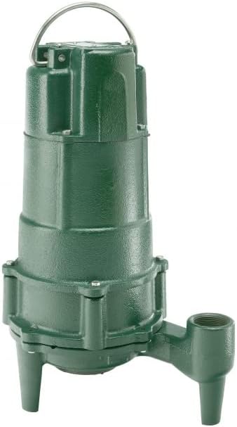 Green cast iron grinder pump with handle, discharge port on side, and cylindrical body with ribbed sections.