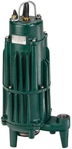 Green cast iron grinder pump with vertical ribbed body, carrying handle, discharge port, and feet for ground installation.