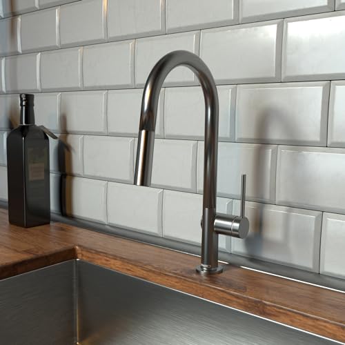 Brushed black chrome high-arc kitchen faucet with pull-down spray head mounted above wooden countertop and white subway tile 