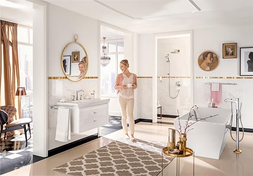 Chrome widespread bathroom faucet with dual lever handles and pop-up drain installed on white sink vanity.