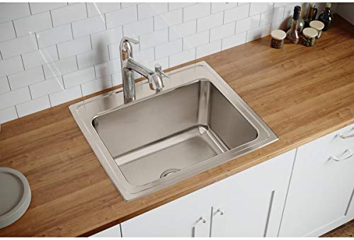 Stainless steel drop-in kitchen sink with single bowl and three pre-drilled holes for faucet mounted in wood countertop.