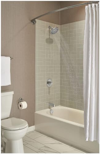 Chrome 7-inch circular shower head mounted on bathroom wall above tub with white curtain rod and white shower curtain.