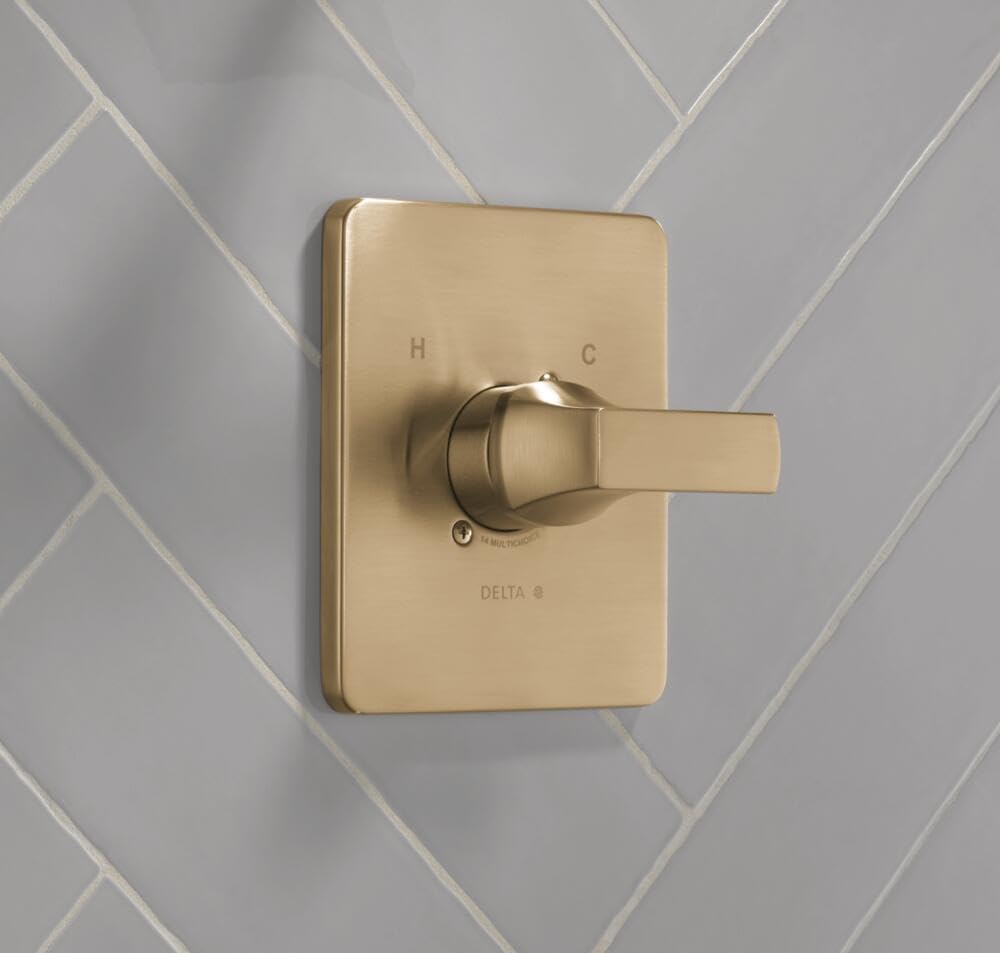 Champagne bronze shower valve trim with rectangular backplate, single lever handle, and hot/cold markings mounted on tile.