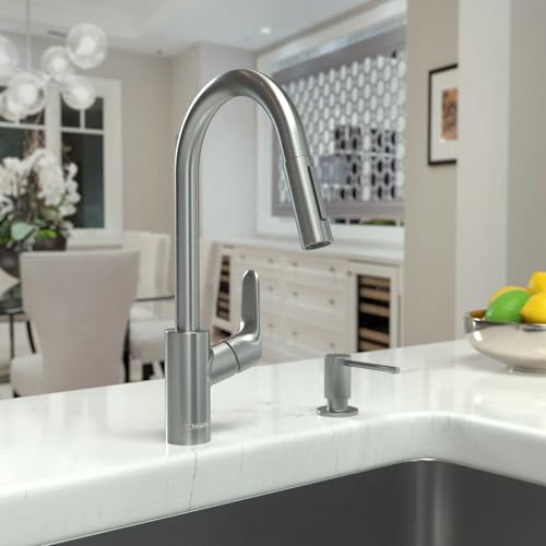 Steel arc kitchen faucet with pull-down spray head and single lever handle installed on white countertop.