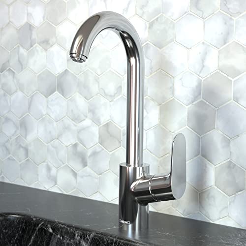 Polished chrome bar faucet with curved spout and single lever handle mounted on hexagonal tile backsplash.