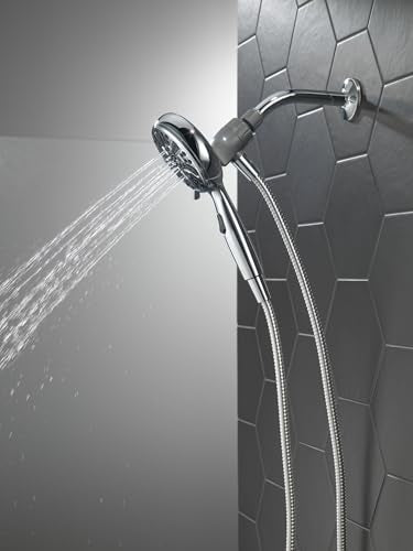 Chrome hand shower with six spray settings mounted on wall with flexible hose, water streaming downward.