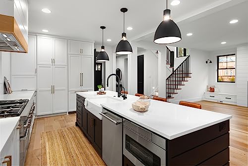 Stainless steel pull-down kitchen faucet with single handle mounted on white countertop in modern kitchen.
